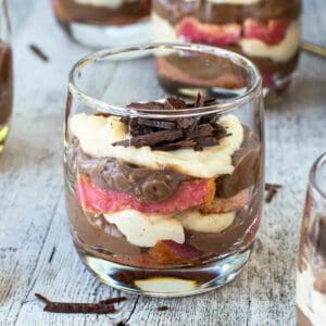 Zuppa Inglese in a glass with a gold spoon standing upright in the dessert.