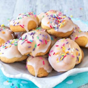 Italian knot cookies on a white plate on a sky blue cloth.