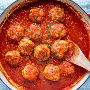 Italian Sausage Meatballs in tomato sauce in a pan viewed from above.