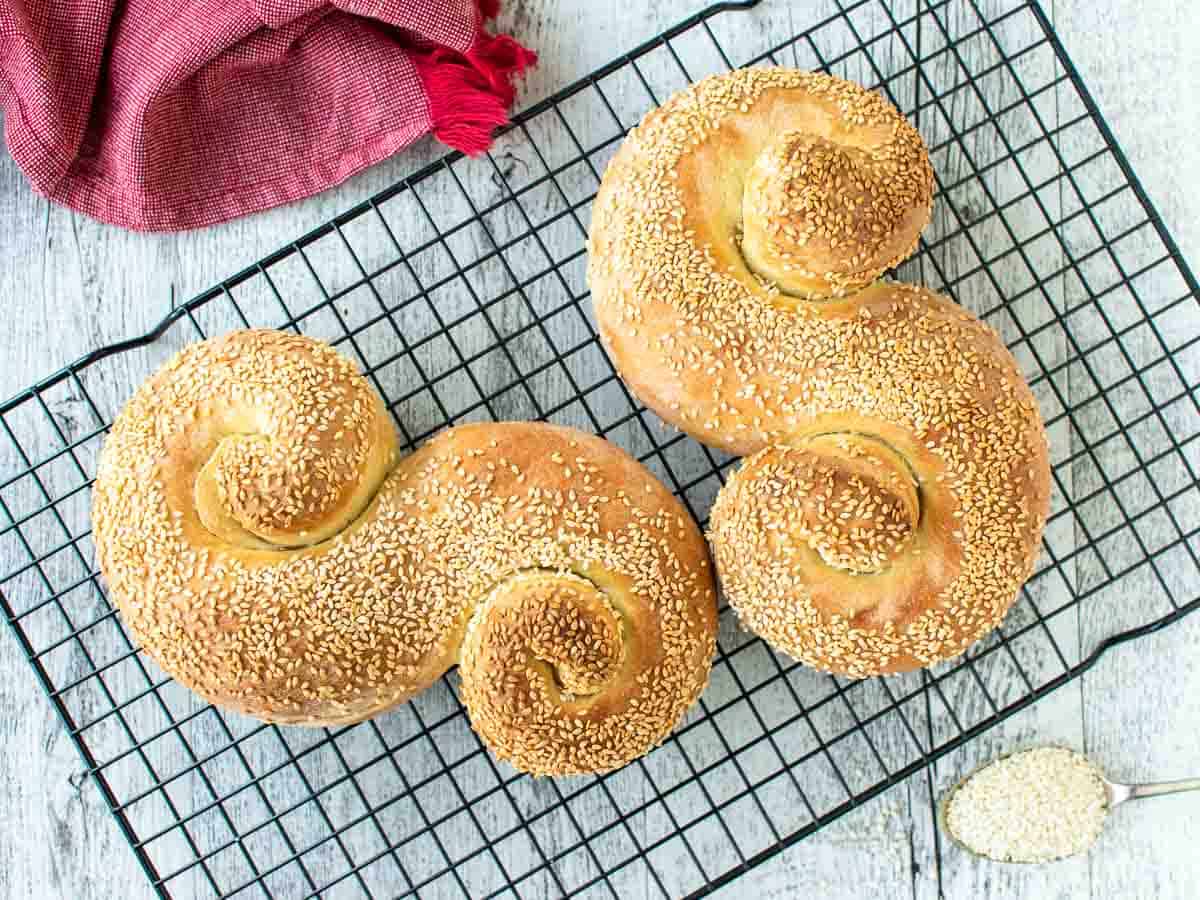 Two "S" shaped breads on a black wire rack.