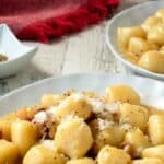 Gnocchi carbonara on a white plate.