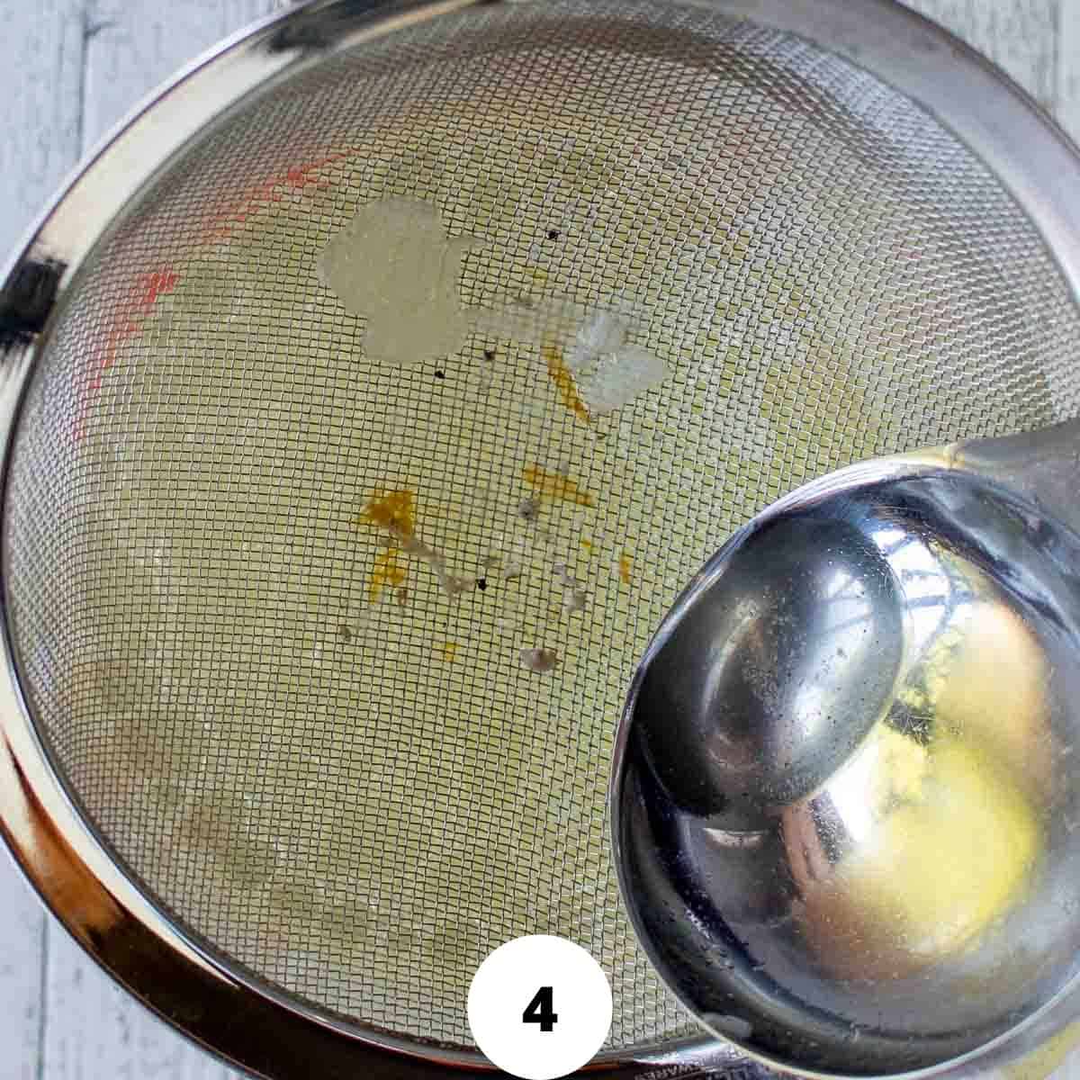 Chicken broth being strained.