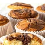 Nutella Muffins with one muffin cut in half revealing the center full of Nutella.