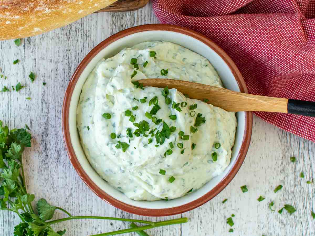 Creamy herb dip in a bowl viewed from above.