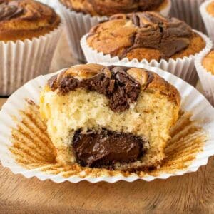 Nutella Muffins with one muffin cut in half revealing the center full of Nutella.