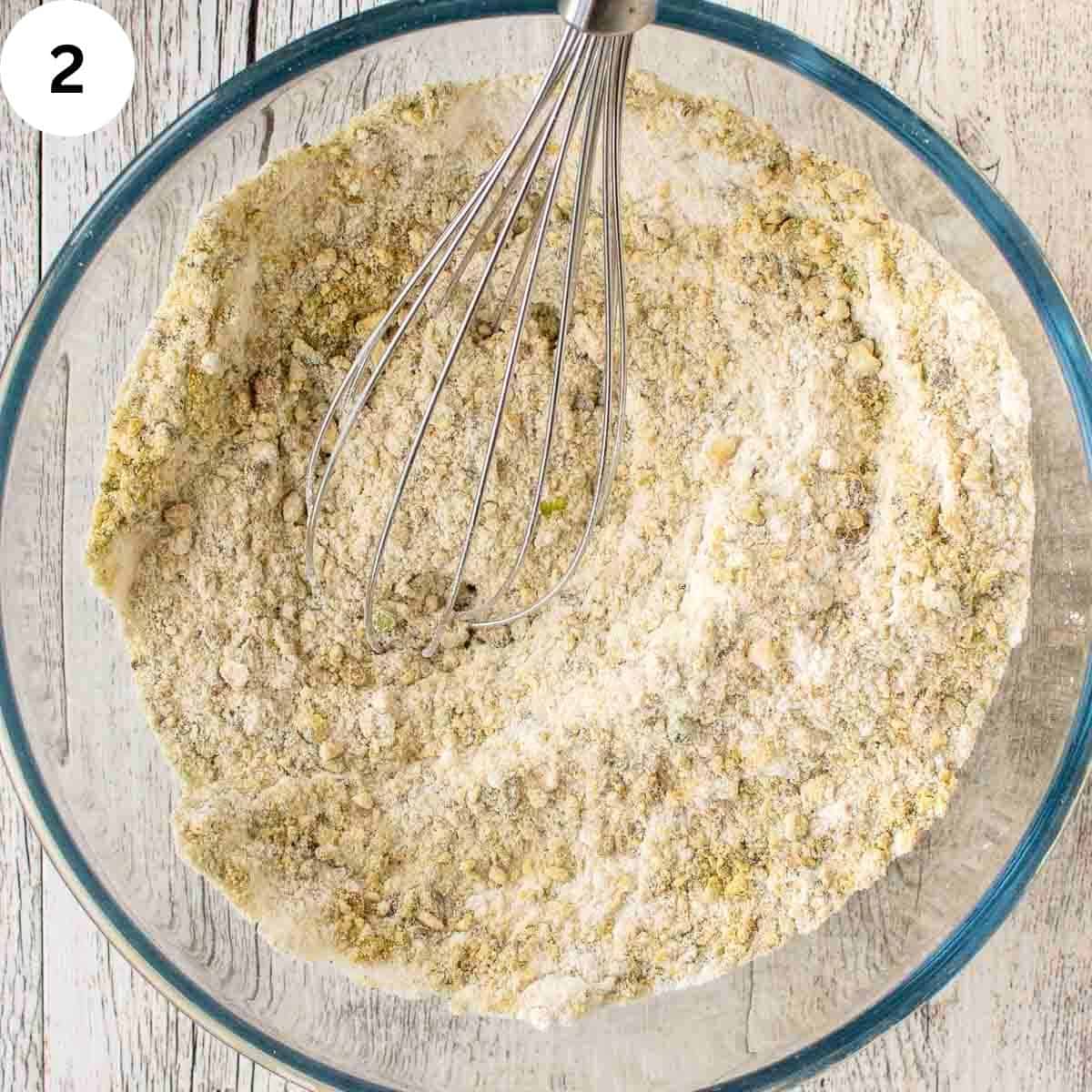 Mixing dry ingredients with a whisk.