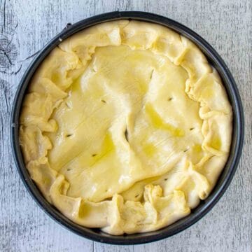 Overhead viewed of pastry topped pie ready for baking.