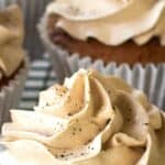 Close up of buttercream swirl on brown cupcake.