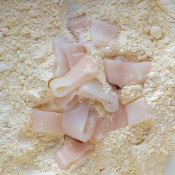 Calamari rings on flour ready for tossing.