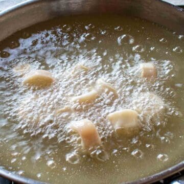 Calamari frying in hot oil.