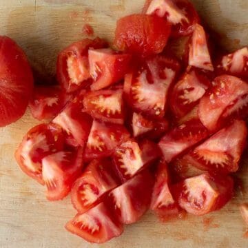 Chopped tomatoes on a wooden board.
