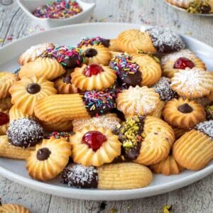 Italian Butter Cookies with various toppings on a white plate.