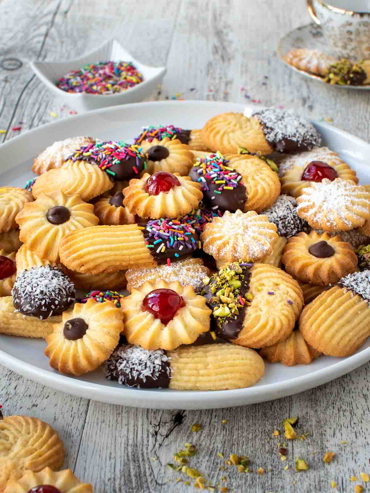 Italian Butter Cookies with various toppings on a white plate.