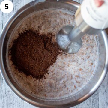 Cocoa powder floating on top of milky liquid.