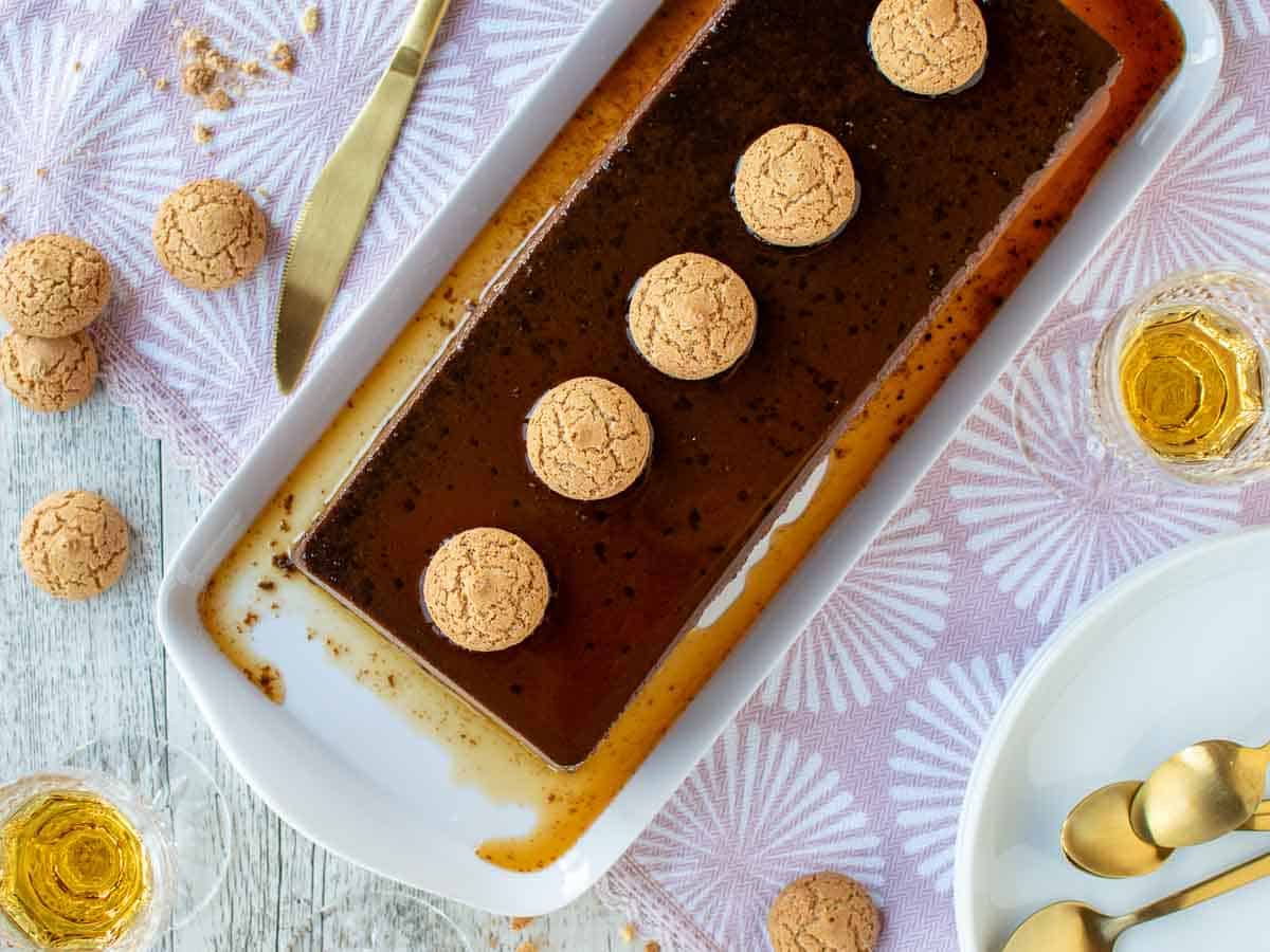 Overhead view of chocolate cream caramel dessert with amaretti cookies lined on top.