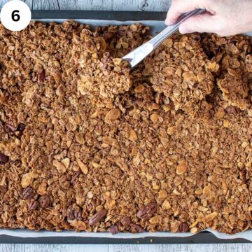 Overhead view of homemade granola on a baking sheet.