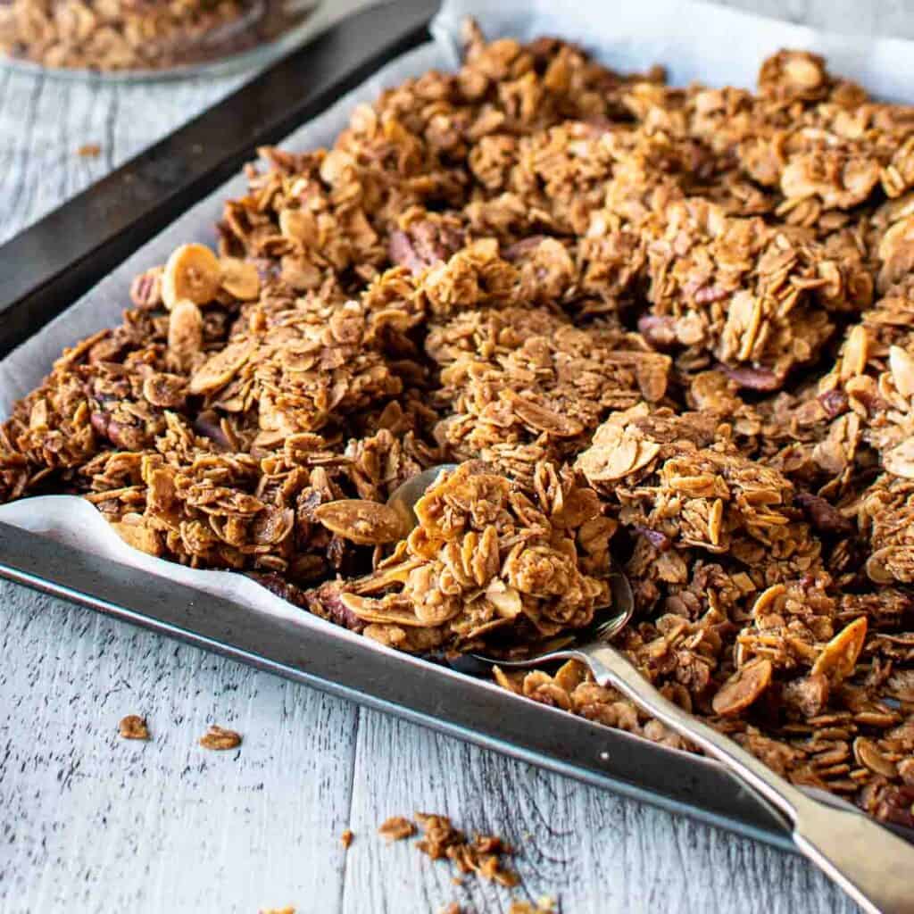 Cinnamon Granola clusters on a baking sheet.