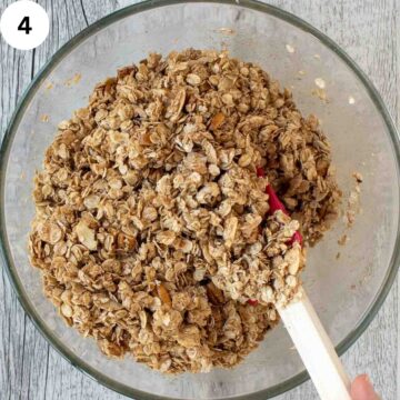 Homemade granola ingredients being mixed with a spatula.