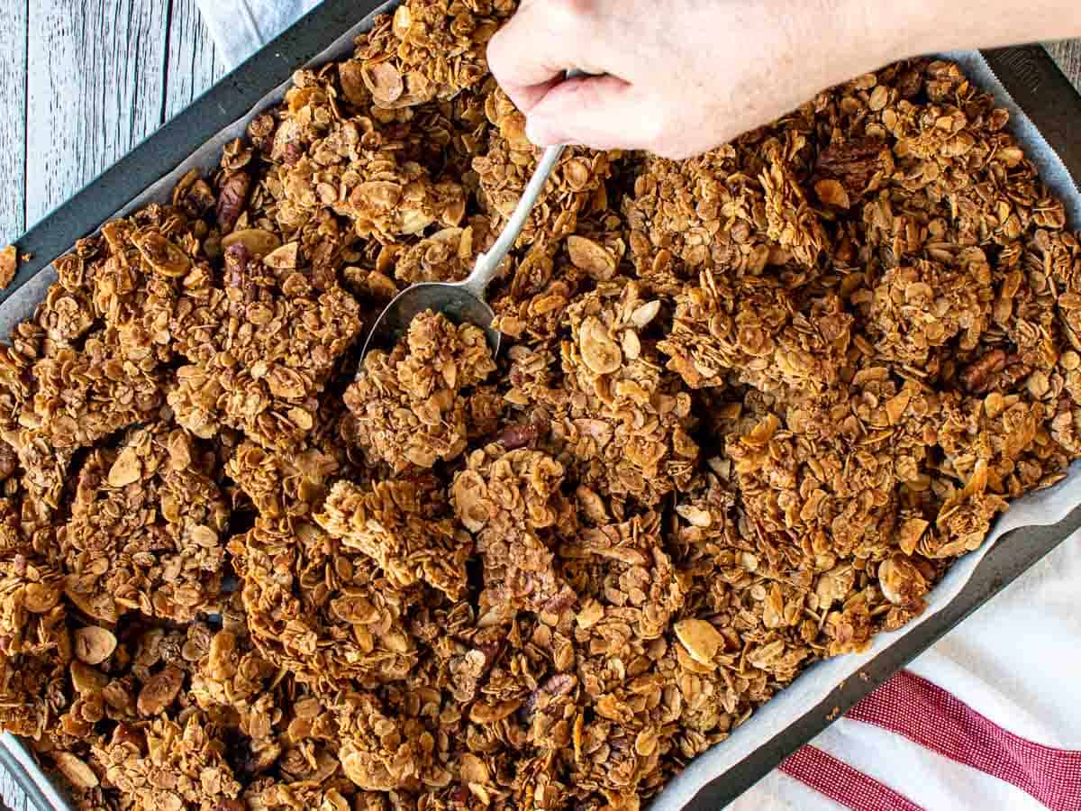 Overhead view of homemade granola on a baking sheet.