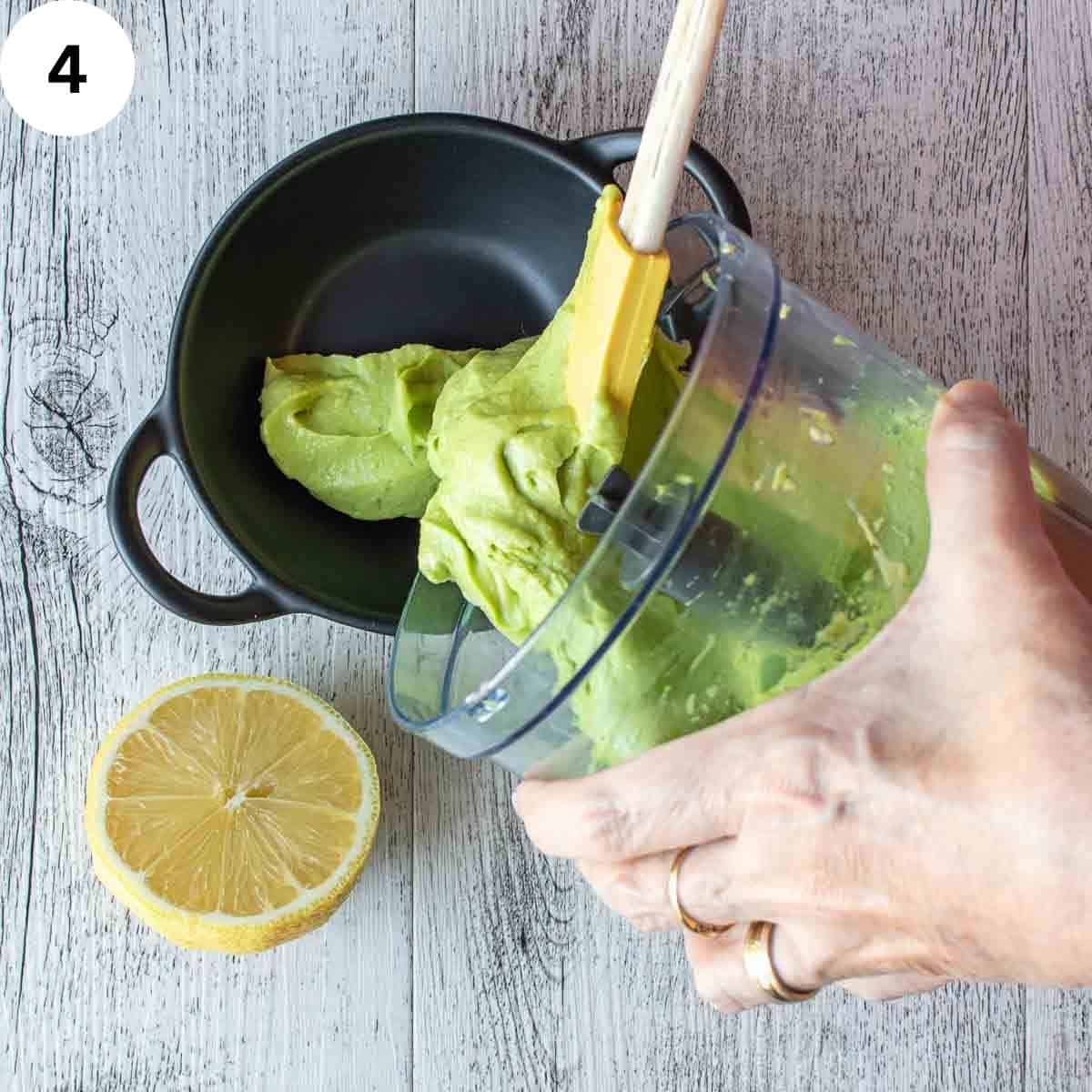 Smooth green spread being poured out into serving dish.