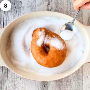 Italian Donut being coated in sugar.