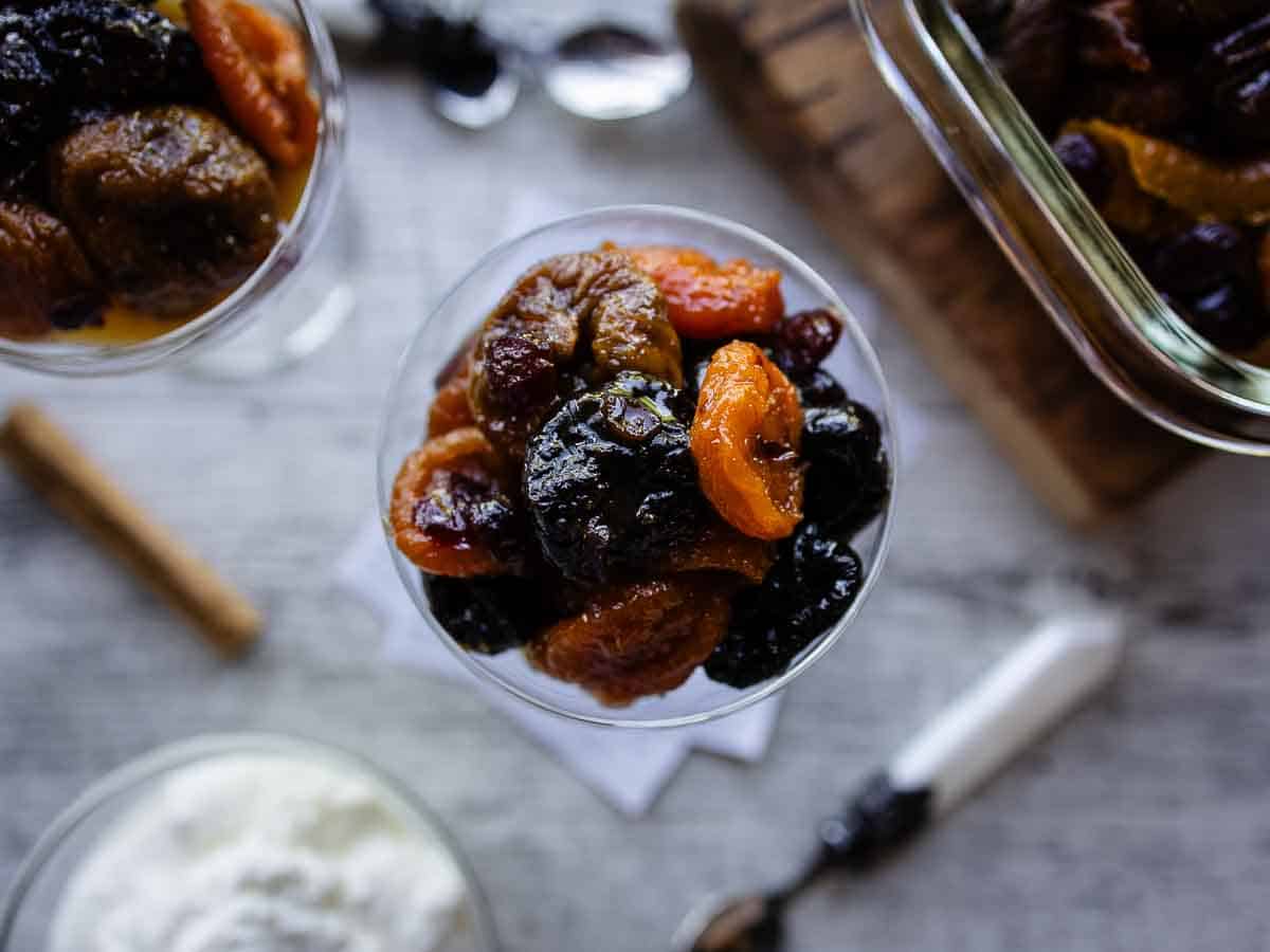 Overhead view of stewed dried fruit in a coupe glass.