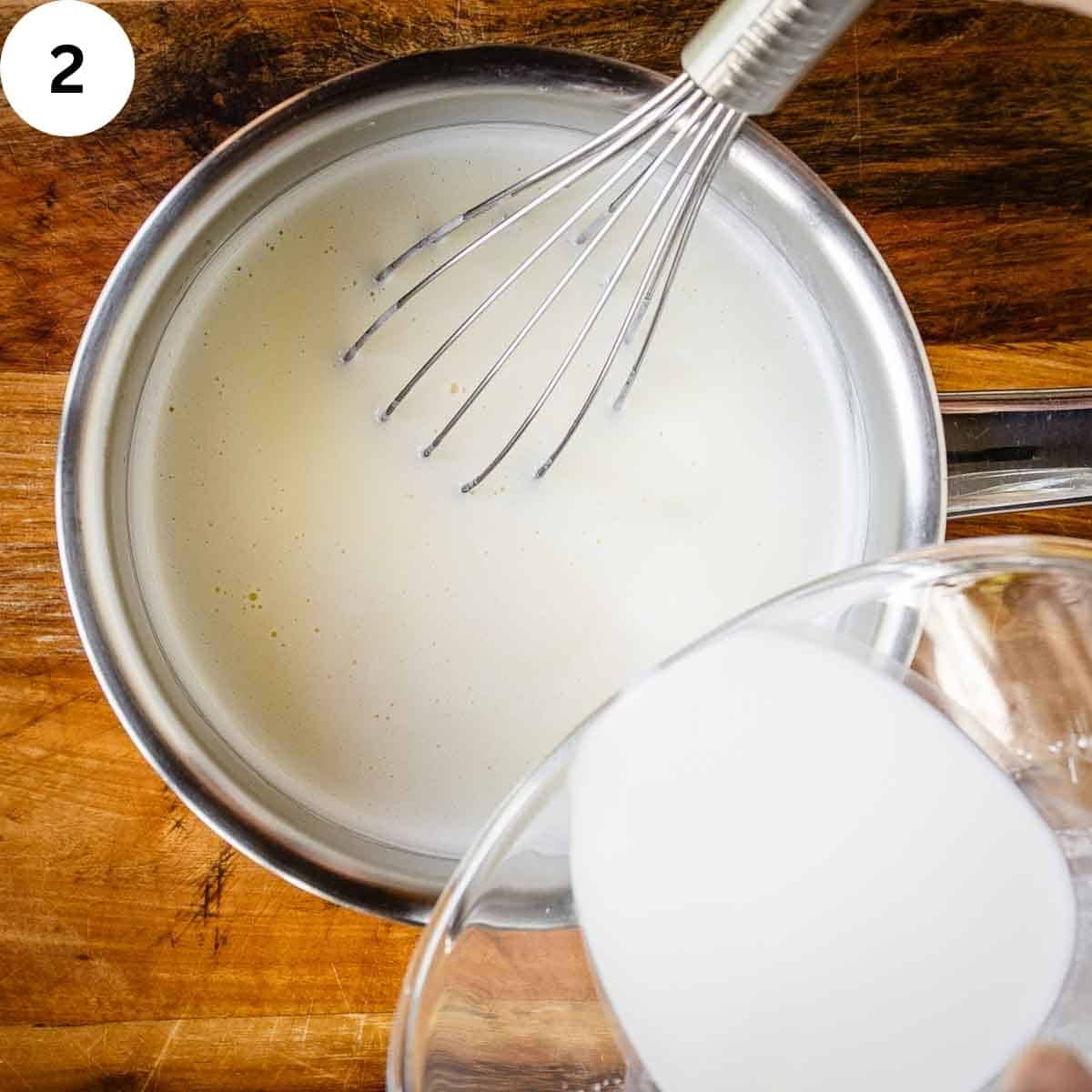 Adding the cornstarch slurry to milk and cream in a saucepan.