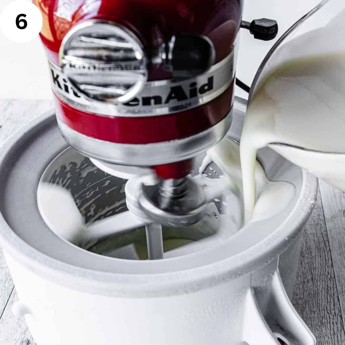 White liquid being poured into stand mixer ice cream maker.
