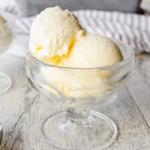 Scoops of Mascarpone Ice Cream in a glass dessert bowl.