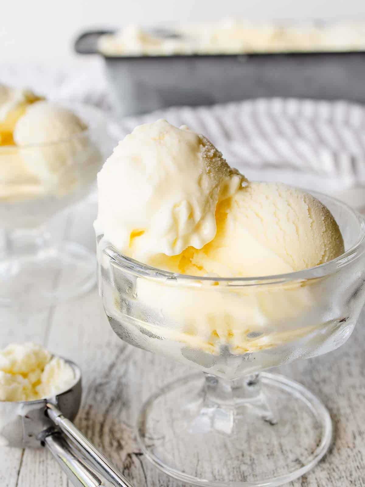 Scoops of Mascarpone Ice Cream in  a glass dessert bowl.