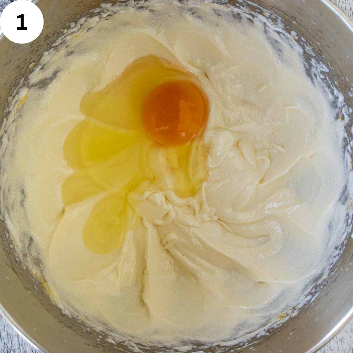 A egg cracked onto creamy butter mixture.