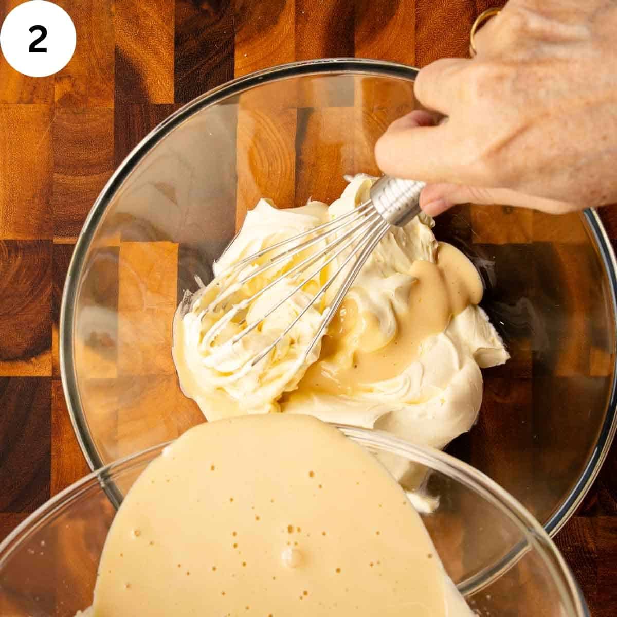 Mascarpone in a bowl with yellow creamy mixture being poured in.