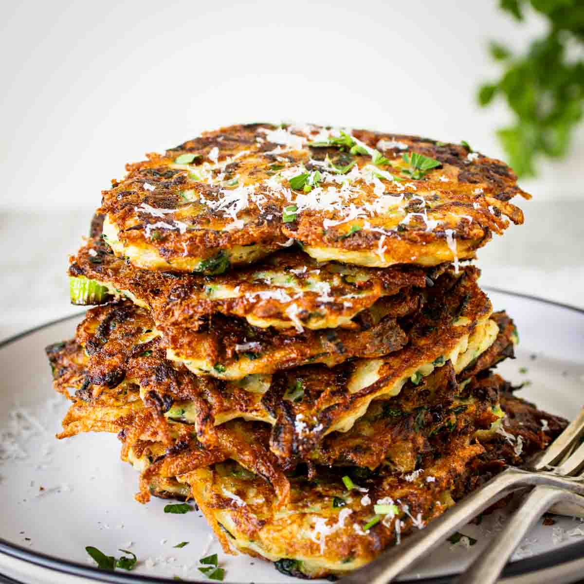 Italian zucchini fritters stacked on top of one another.