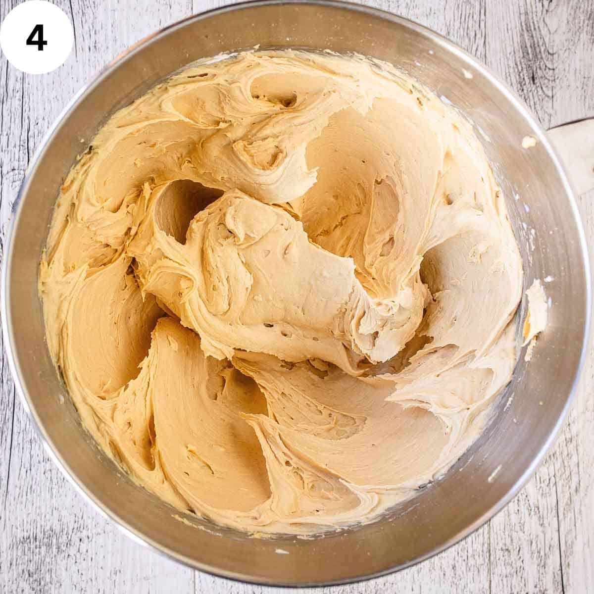 Light and fluffy buttercream in a stainless steel bowl.