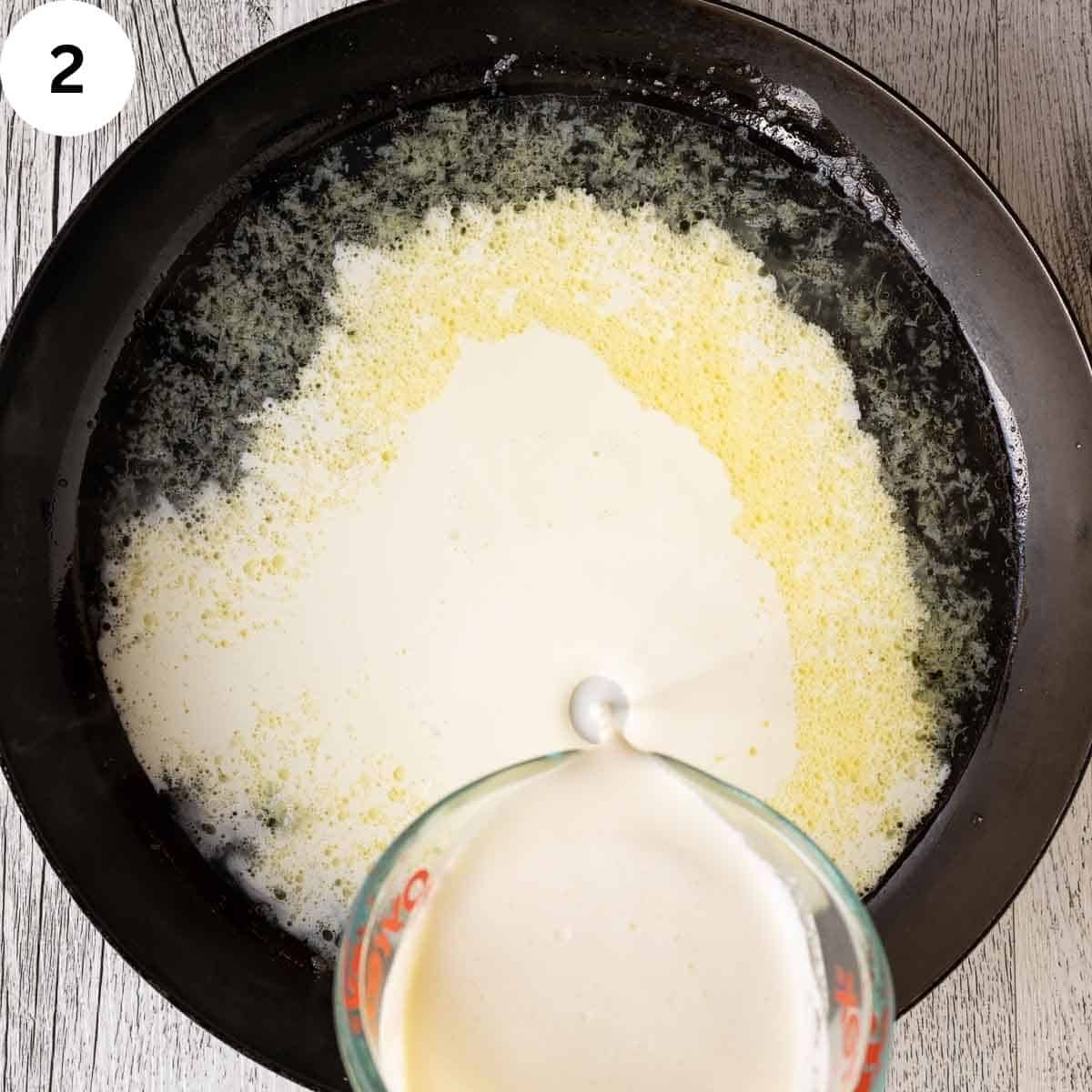 Cream being added to a skillet.