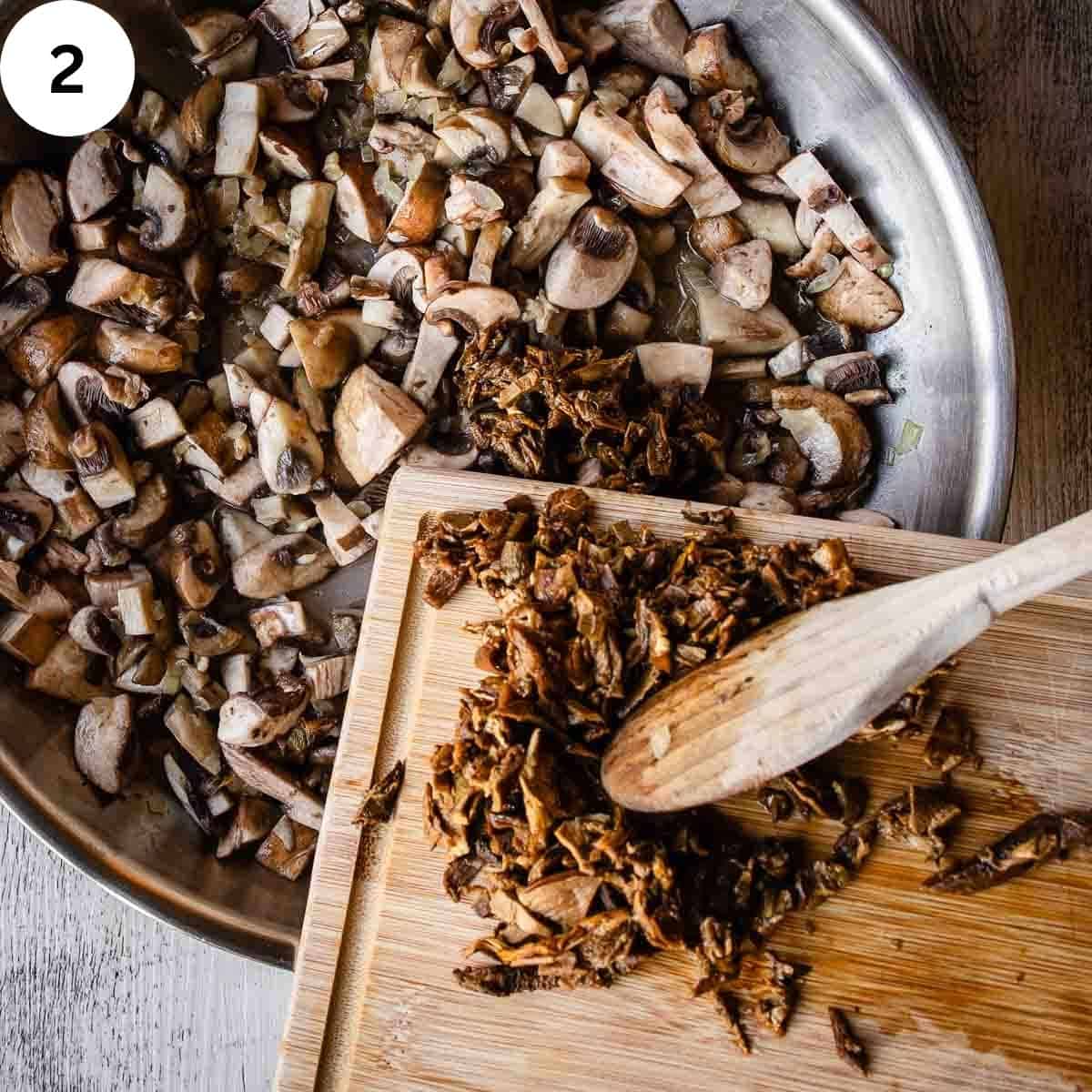 Adding chopped porcini mushrooms to a pan full of chopped mushrooms.
