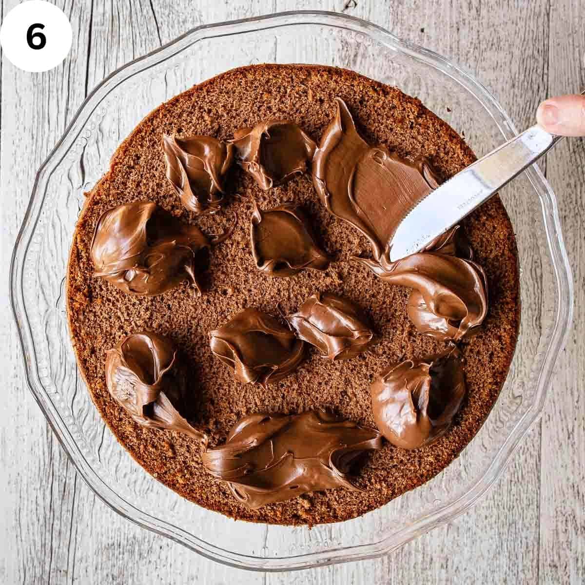 Dollops of chocolate spread on a chocolate cake viewed from above.