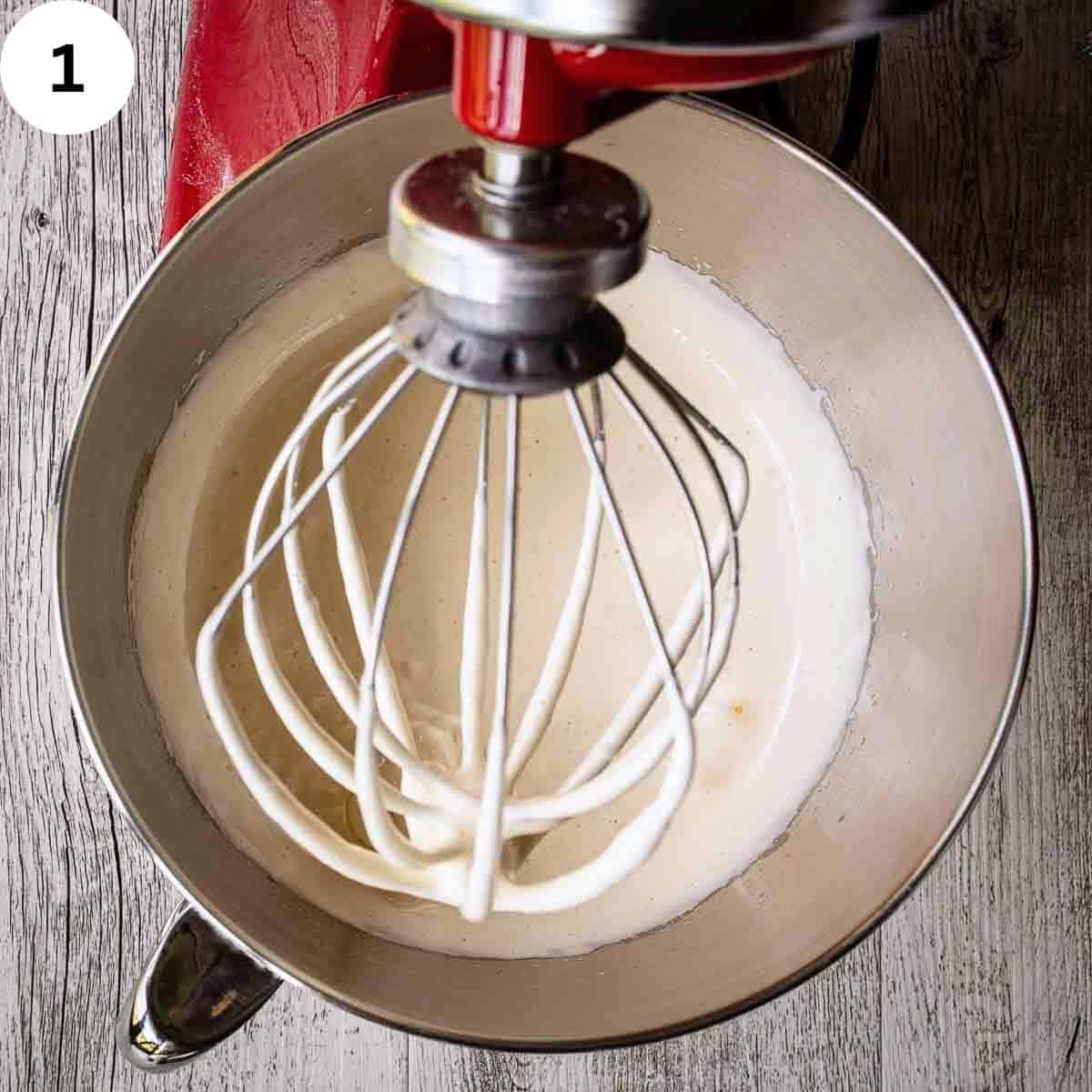 Thick pale yellow mixture in the bowl of a stand mixer.