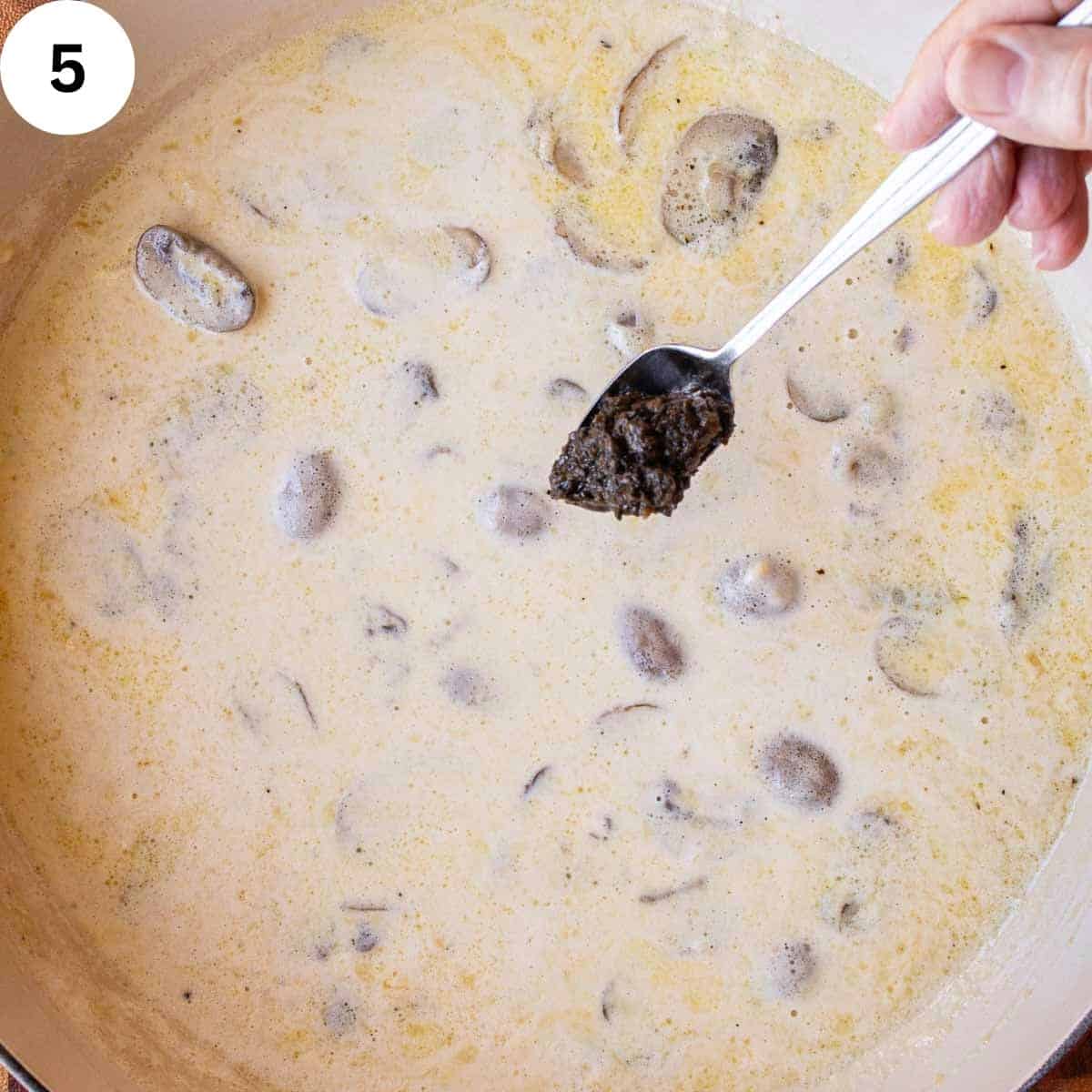 A spoonful of black paste to creamy sauce.