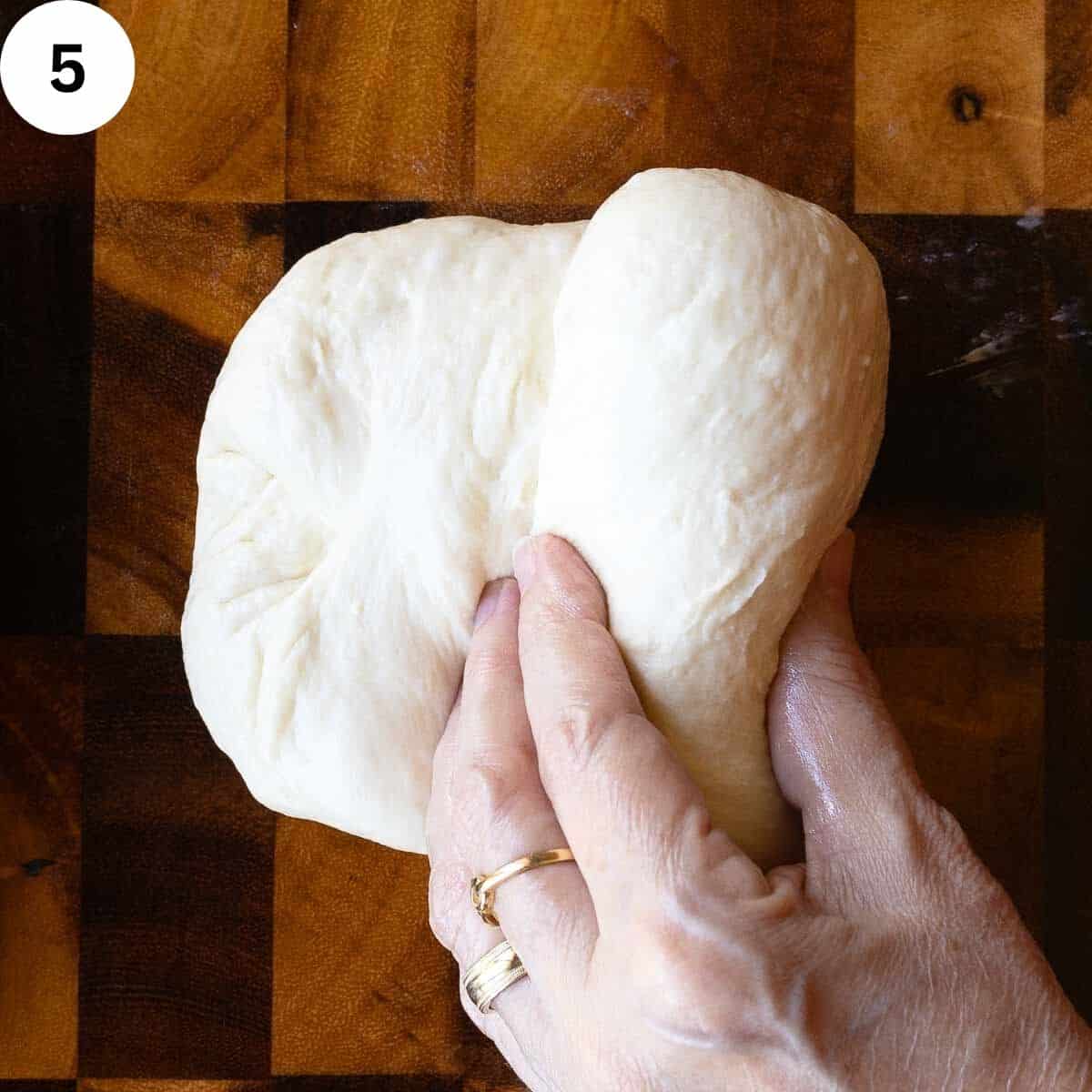 Rolling bread dough like a swiss roll.