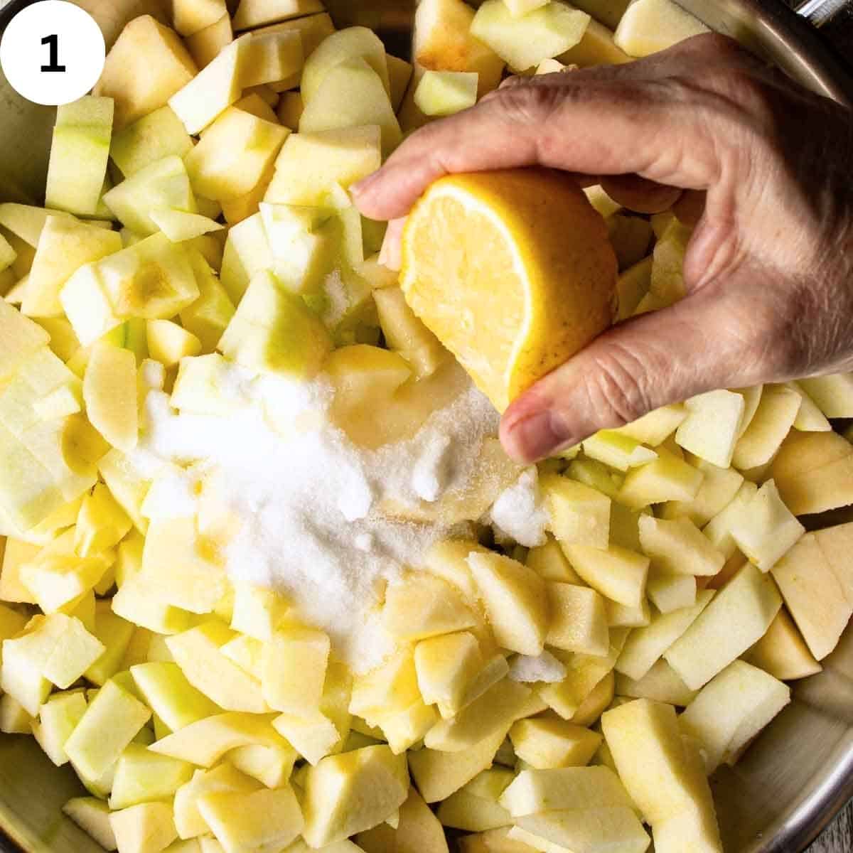 Squeezing lemon juice onto chopped apples.