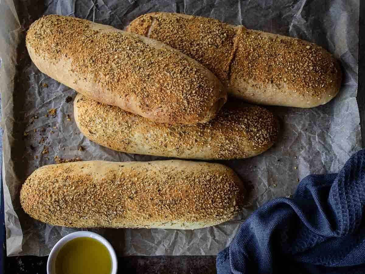 Overhead view of four long bread rolls.
