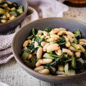 Beans and greens recipe prepared and served in a bowl.