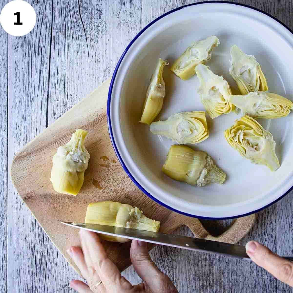 Cutting canned artichokes hearts.