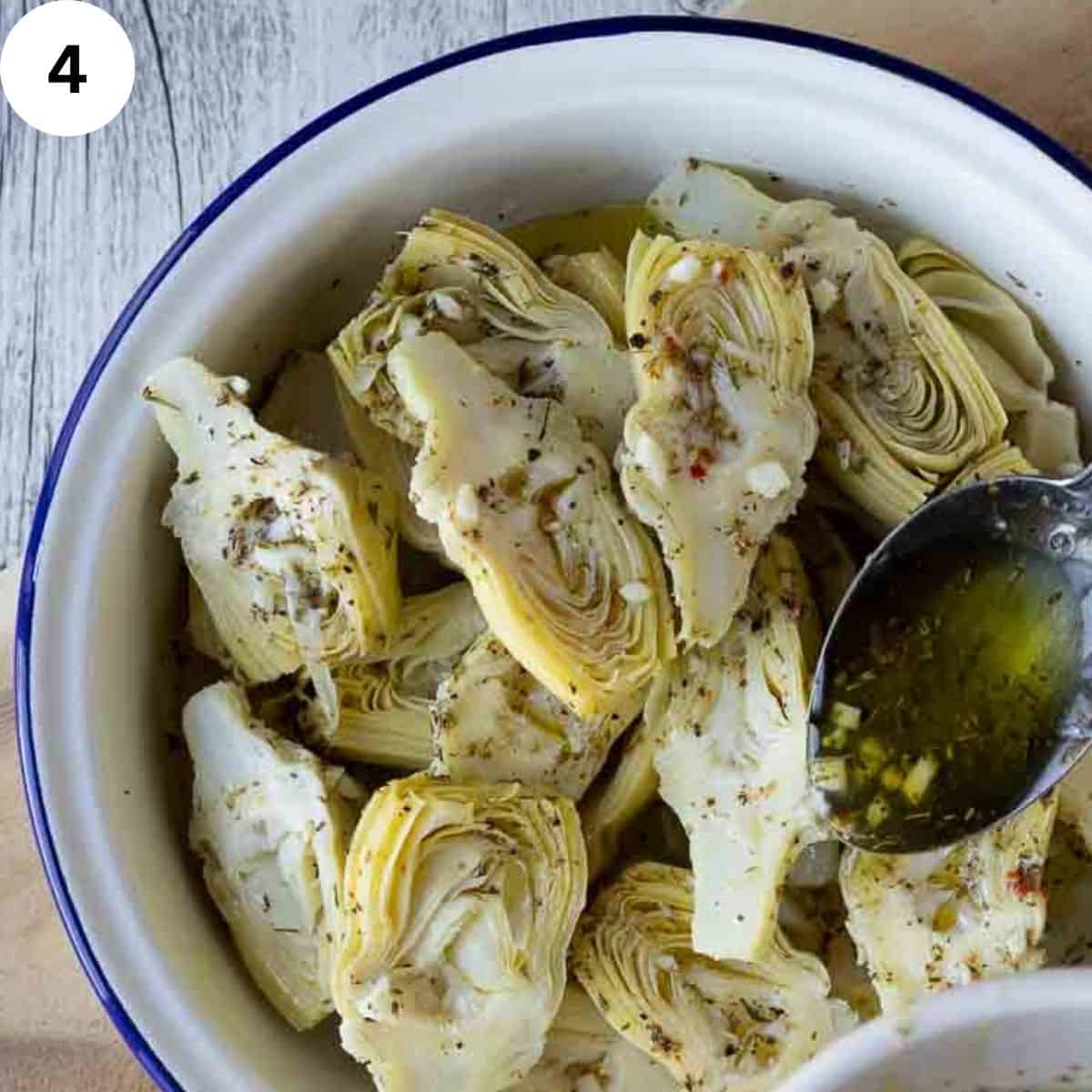 Artichokes marinating in a herby dressing.