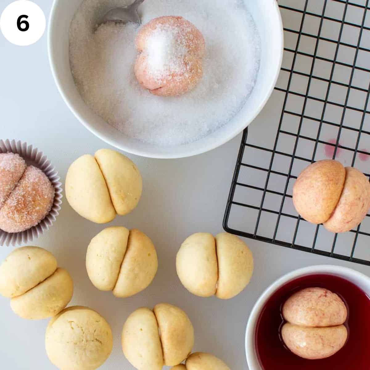 Dipping joined peach cookies in alkermes and then sugar.