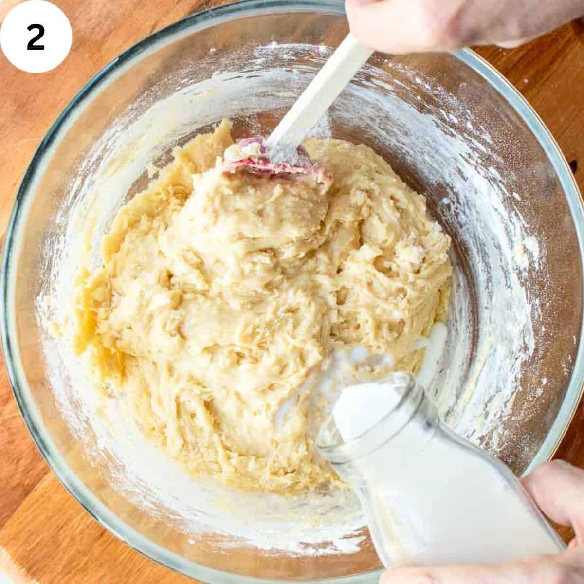 Stirring milk into cookie batter.
