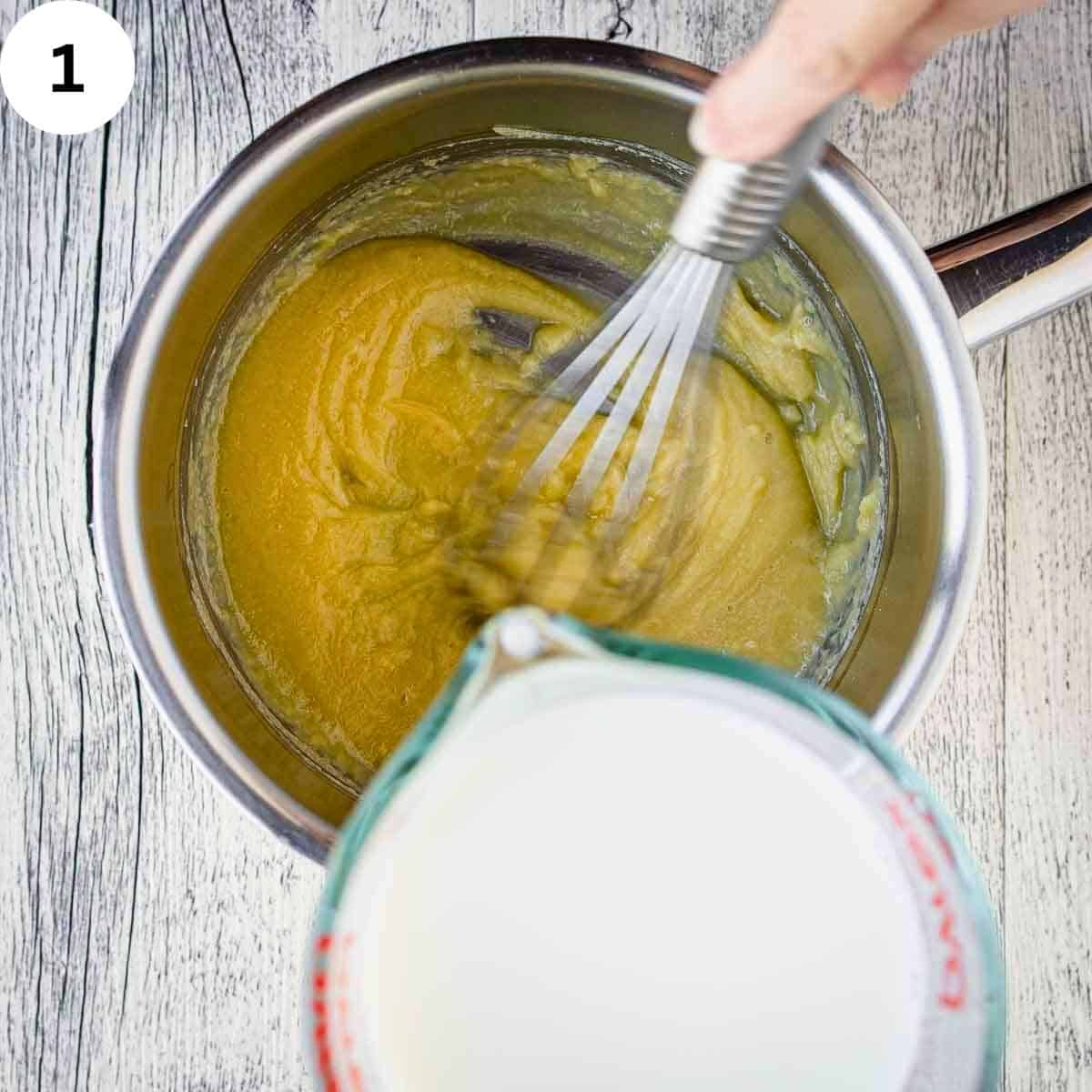 Adding milk to yellow mixture in a saucepan.