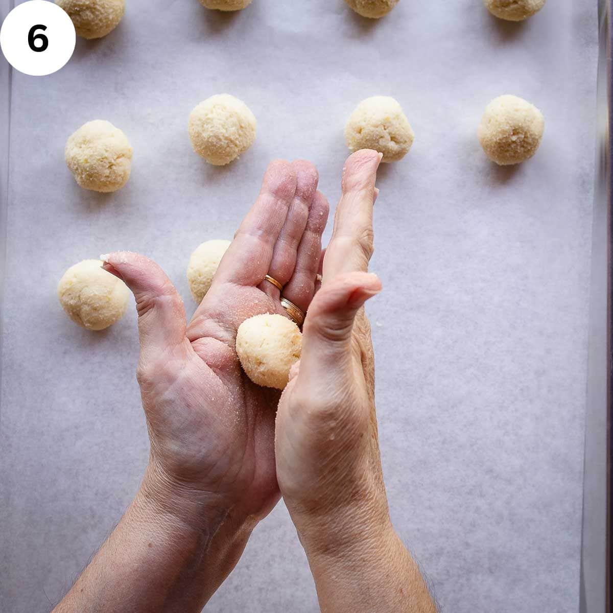 Rolling cookie dough between palms.