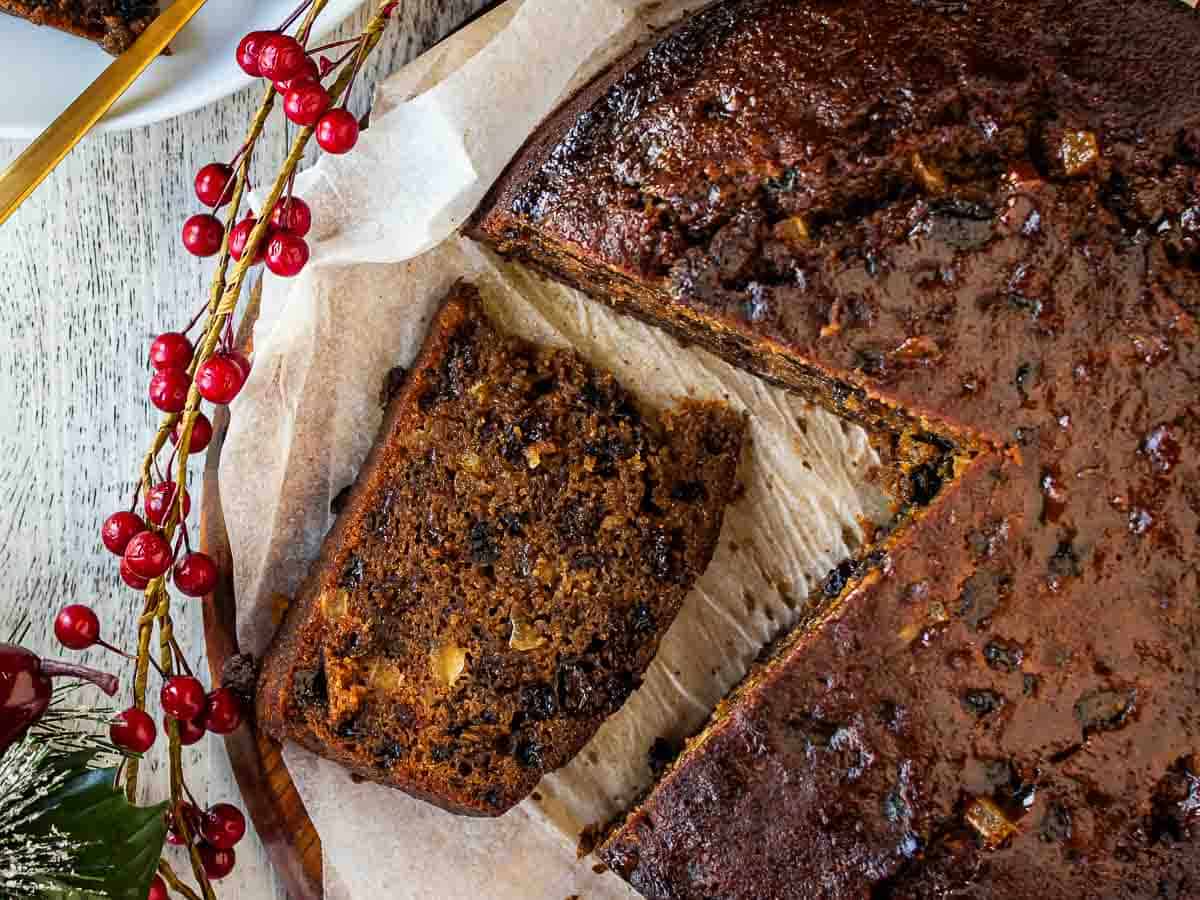 Overhead view of a slice of fruit cake cut from cake.